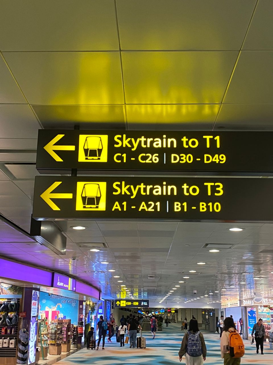 Directional signs inside Changi Airport guiding passengers to Terminal 1 Coach Bay